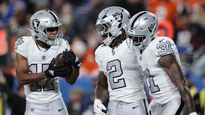 Nov 6, 2025; Denver, Colorado, USA; Las Vegas Raiders wide receiver Tyler Lockett (17) reacts with running back Ashton Jeanty (2) and running back Raheem Mostert (31) during the first half at Empower Field at Mile High. Mandatory Credit: Isaiah J. Downing-Imagn Images