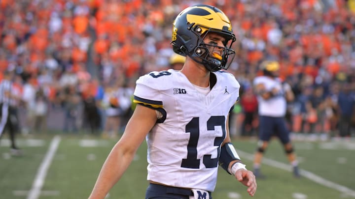 Oct 19, 2024; Champaign, Illinois, USA;  Michigan Wolverines quarterback Jack Tuttle (13) reacts after turning over possession of the ball against the Illinois Fighting Illini during the second half at Memorial Stadium. Mandatory Credit: Ron Johnson-Imagn Images