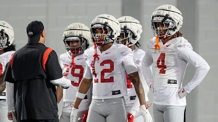 Ohio State Buckeyes cornerbacks Devin Sanchez (4) Bryce West (12) listen to coach Tim Walton during spring football practice at the Woody Hayes Athletic Center in Columbus on March 19, 2025.