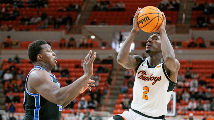 Feb 17, 2024; Stillwater, Oklahoma, USA; Oklahoma State Cowboys forward Eric Dailey Jr. (2) shoots the ball over Brigham Young Cougars forward Fousseyni Traore (45) during the first half at Gallagher-Iba Arena. Mandatory Credit: William Purnell-Imagn Images