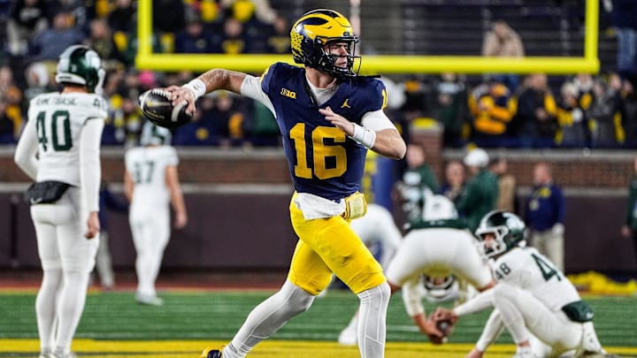 Michigan quarterback Davis Warren (16) warms up before the Michigan State game at Michigan Stadium in Ann Arbor on Saturday, Oct. 26, 2024.
