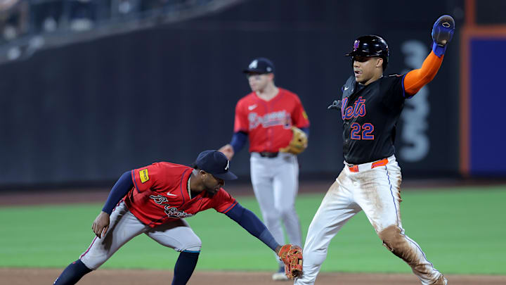 Aug 14, 2025; New York City, New York, USA; New York Mets right fielder Juan Soto (22) reacts after stealing second base as Atlanta Braves second baseman Ozzie Albies (1) applies a late tag during the sixth inning at Citi Field. Mandatory Credit: Brad Penner-Imagn Images