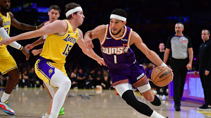 Dec 1, 2025; Los Angeles, California, USA; Phoenix Suns guard Devin Booker (1) moves the ball against Los Angeles Lakers guard Austin Reaves (15) during the first half at Crypto.com Arena. Mandatory Credit: Gary A. Vasquez-Imagn Images Dec 1, 2025; Los Angeles, California, USA; Phoenix Suns guard Devin Booker (1) moves the ball against Los Angeles Lakers guard Austin Reaves (15) during the first half at Crypto.com Arena. Mandatory Credit: Gary A. Vasquez-Imagn Images