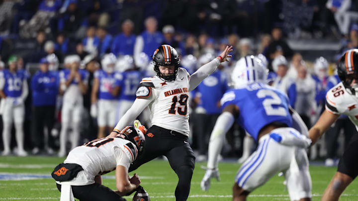 Oct 18, 2024; Provo, Utah, USA; Oklahoma State Cowboys place kicker Logan Ward (19) kicks an extra point against the Brigham Young Cougars during the second quarter at LaVell Edwards Stadium. Mandatory Credit: Rob Gray-Imagn Images
