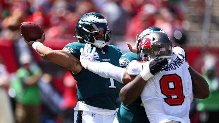 Sep 29, 2024; Tampa, Florida, USA; Philadelphia Eagles quarterback Jalen Hurts (1) is pressured by Tampa Bay Buccaneers linebacker Joe Tryon-Shoyinka (9) in the second quarter at Raymond James Stadium. 