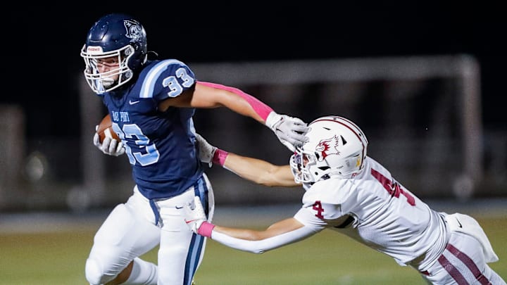Bay Port High School running back Brady Moon (33) stiff arms De Pere's Jonathen Moore (4) during a Fox Valley Association game on Friday, October 3, 2025 Tork Mason/USA TODAY NETWORK-Wisconsin 