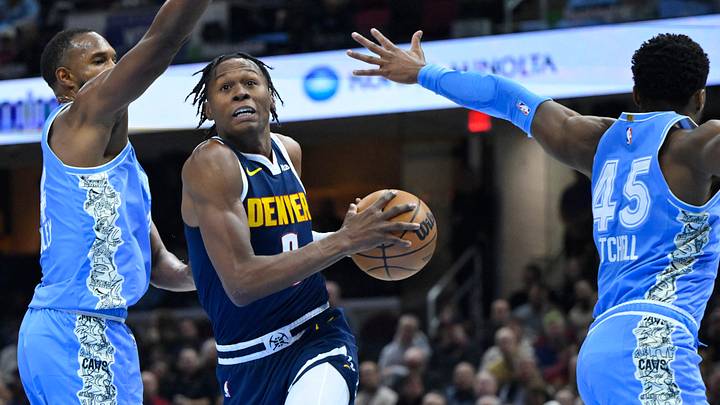 Dec 5, 2024; Cleveland, Ohio, USA; Denver Nuggets forward Peyton Watson (8) drives between Cleveland Cavaliers forward Evan Mobley (4) and guard Donovan Mitchell (45) in the second quarter at Rocket Mortgage FieldHouse. Mandatory Credit: David Richard-Imagn Images Dec 5, 2024; Cleveland, Ohio, USA; Denver Nuggets forward Peyton Watson (8) drives between Cleveland Cavaliers forward Evan Mobley (4) and guard Donovan Mitchell (45) in the second quarter at Rocket Mortgage FieldHouse. Mandatory Credit: David Richard-Imagn Images