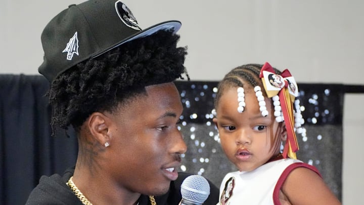 Friends and family celebrate after Booker High defensive end/wide receiver Chauncey Kennon announces he has selected Florida State University to commit to during a party Sunday afternoon, July 6, 2025 at the DeSoto Boys and Girls Club in Bradenton.