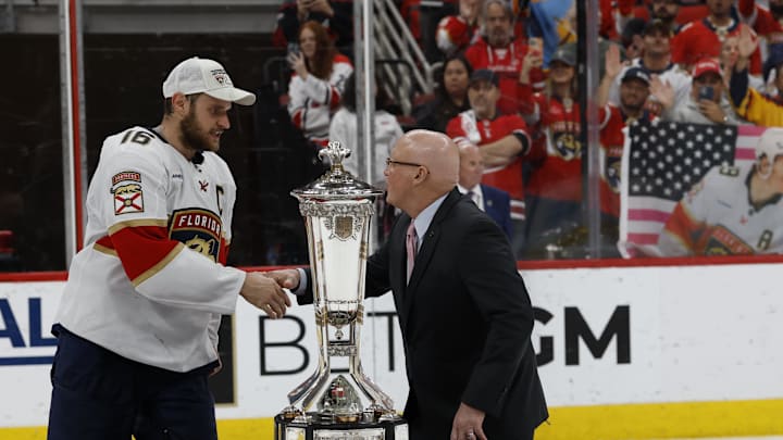 May 28, 2025; Raleigh, North Carolina, USA; Florida Panthers defenseman Jaycob Megna (6) shakes hand with NHL deputy commissioner Bill Daly while presenting the Prince of Wales trophy after game five of the Eastern Conference Final of the 2025 Stanley Cup Playoffs at Lenovo Center. Mandatory Credit: Geoff Burke-Imagn Images