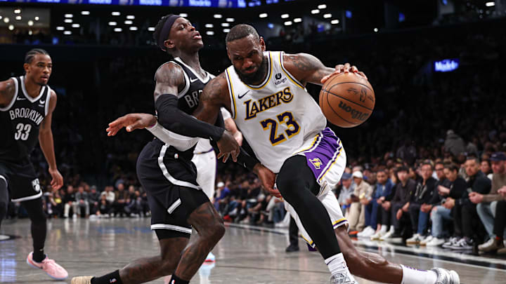 Mar 31, 2024; Brooklyn, New York, USA; Los Angeles Lakers forward LeBron James (23) dribbles against Brooklyn Nets guard Dennis Schroder (17) during the second half at Barclays Center. Mandatory Credit: Vincent Carchietta-Imagn Images