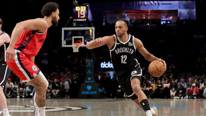 Mar 28, 2025; Brooklyn, New York, USA; Brooklyn Nets forward Tosan Evbuomwan (12) drives to the basket against Los Angeles Clippers guard Ben Simmons (25) during the fourth quarter at Barclays Center. Mandatory Credit: Brad Penner-Imagn Images Mar 28, 2025; Brooklyn, New York, USA; Brooklyn Nets forward Tosan Evbuomwan (12) drives to the basket against Los Angeles Clippers guard Ben Simmons (25) during the fourth quarter at Barclays Center. Mandatory Credit: Brad Penner-Imagn Images