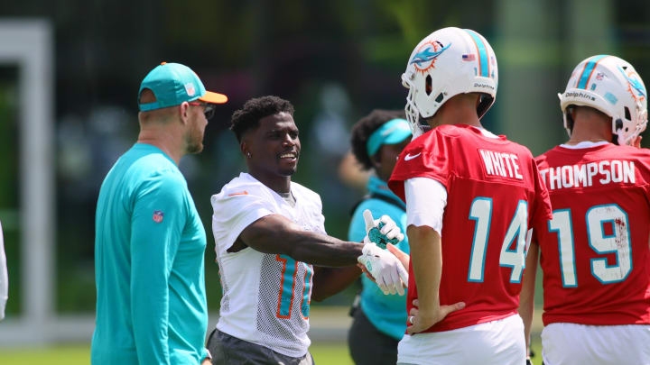 Jun 4, 2024; Miami Gardens, FL, USA; Miami Dolphins wide receiver Tyreek Hill (10) shakes hands with quarterback Mike White (14) during mandatory minicamp at Baptist Health Training Complex. Jun 4, 2024; Miami Gardens, FL, USA; Miami Dolphins wide receiver Tyreek Hill (10) shakes hands with quarterback Mike White (14) during mandatory minicamp at Baptist Health Training Complex.