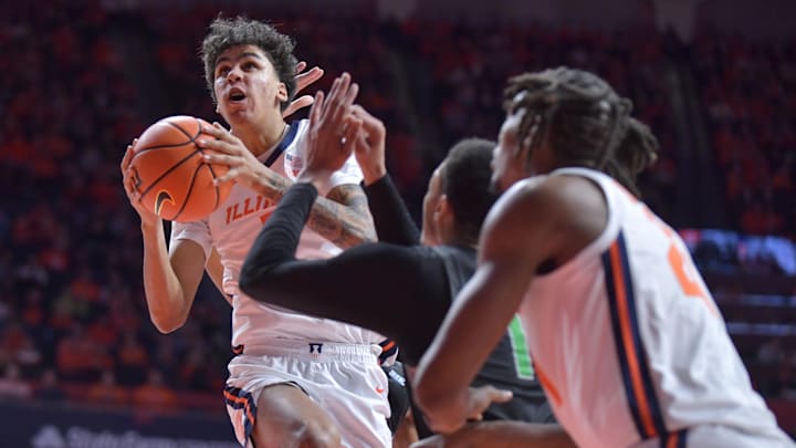 Dec 29, 2024; Champaign, Illinois, USA;  Illinois Fighting Illini forward Will Riley (7) drives to the basket during the first half against the Chicago State Cougars at State Farm Center. Mandatory Credit: Ron Johnson-Imagn Images