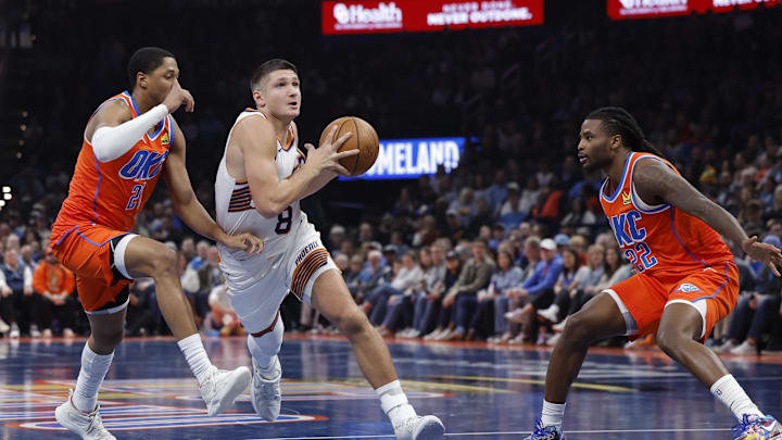 Dec 10, 2025; Oklahoma City, Oklahoma, USA; Phoenix Suns guard Grayson Allen (8) drives between Oklahoma City Thunder guard Aaron Wiggins (21) and guard Cason Wallace (22) during the second quarter at Paycom Center. Mandatory Credit: Alonzo Adams-Imagn Images Dec 10, 2025; Oklahoma City, Oklahoma, USA; Phoenix Suns guard Grayson Allen (8) drives between Oklahoma City Thunder guard Aaron Wiggins (21) and guard Cason Wallace (22) during the second quarter at Paycom Center. Mandatory Credit: Alonzo Adams-Imagn Images