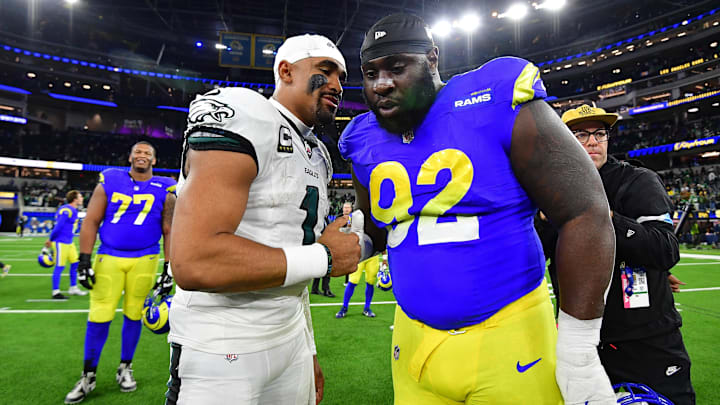 Nov 24, 2024; Inglewood, California, USA; Philadelphia Eagles quarterback Jalen Hurts (1) meets with Los Angeles Rams defensive tackle Neville Gallimore (92)  at SoFi Stadium. Mandatory Credit: Gary A. Vasquez-Imagn Images