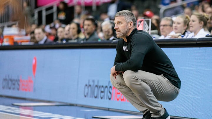 Mar 12, 2024; Kansas City, MO, USA; West Virginia Mountaineers coach Josh Eilert watches game play during the first half against the Cincinnati Bearcats at T-Mobile Center. Mandatory Credit: William Purnell-Imagn Images