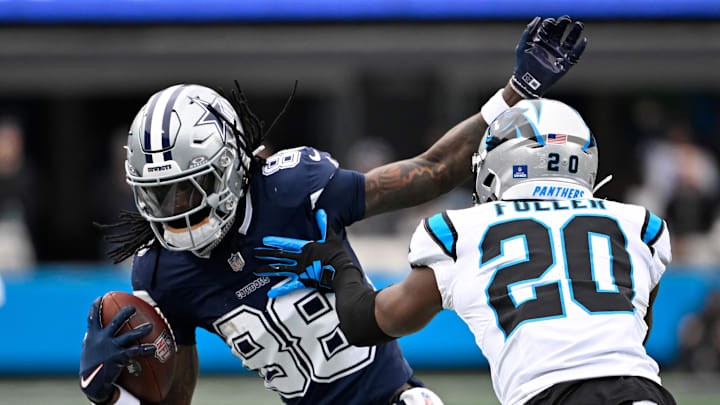 Dec 15, 2024; Charlotte, North Carolina, USA;  Dallas Cowboys wide receiver CeeDee Lamb (88) with the ball as Carolina Panthers safety Jordan Fuller (20) defends in the second quarter at Bank of America Stadium. Mandatory Credit: Bob Donnan-Imagn Images