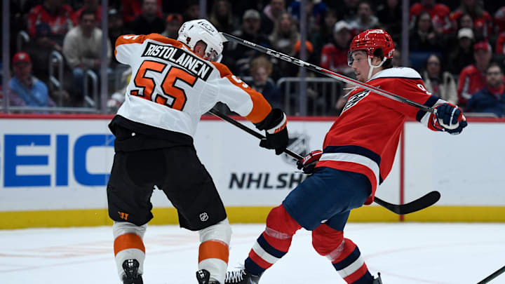 Feb 25, 2026; Washington, District of Columbia, USA; Philadelphia Flyers defenseman Rasmus Ristolainen (55) collides with Washington Capitals right wing Ryan Leonard (9) during the first period at Capital One Arena. Mandatory Credit: Hannah Foslien-Imagn Images