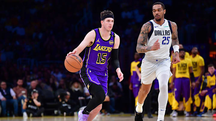 Feb 25, 2025; Los Angeles, California, USA; Los Angeles Lakers guard Austin Reaves (15) dribbles the ball past Dallas Mavericks forward P.J. Washington (25) during the second half at Crypto.com Arena. Mandatory Credit: Gary A. Vasquez-Imagn Images