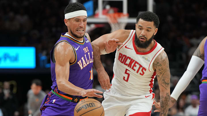 Phoenix Suns guard Devin Booker drives around Houston Rockets guard Fred VanVleet.