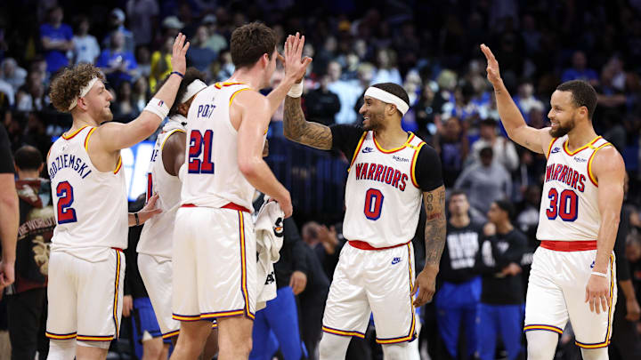 Feb 27, 2025; Orlando, Florida, USA; Golden State Warriors guard Stephen Curry (30) celebrates with guard Gary Payton II (0) center Quinten Post (21) after a play against the Orlando Magic in the fourth quarter at Kia Center. Mandatory Credit: Nathan Ray Seebeck-Imagn Images