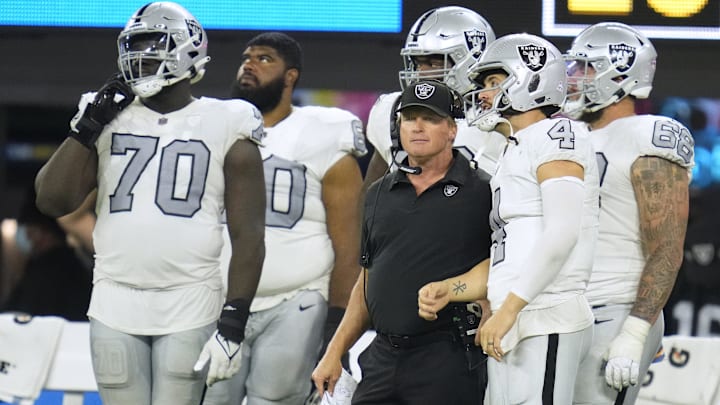 Oct 4, 2021; Inglewood, California, USA; Las Vegas Raiders head coach Jon Gruden talks with quarterback Derek Carr (4) during the second half against the Los Angeles Chargers at SoFi Stadium. Mandatory Credit: Robert Hanashiro-Imagn Images