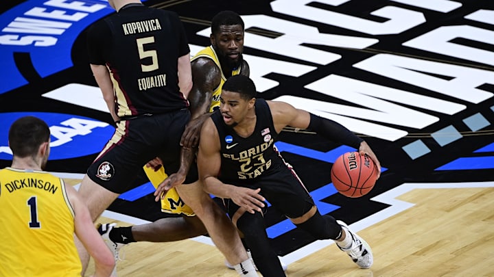 Mar 28, 2021; Indianapolis, IN, USA; Florida State Seminoles guard M.J. Walker (23) drives against Michigan Wolverines center Hunter Dickinson (1) and guard Chaundee Brown (middle) in the first half during the Sweet 16 of the 2021 NCAA Tournament at Bankers Life Fieldhouse. Mandatory Credit: Marc Lebryk-Imagn Images Mar 28, 2021; Indianapolis, IN, USA; Florida State Seminoles guard M.J. Walker (23) drives against Michigan Wolverines center Hunter Dickinson (1) and guard Chaundee Brown (middle) in the first half during the Sweet 16 of the 2021 NCAA Tournament at Bankers Life Fieldhouse. Mandatory Credit: Marc Lebryk-Imagn Images