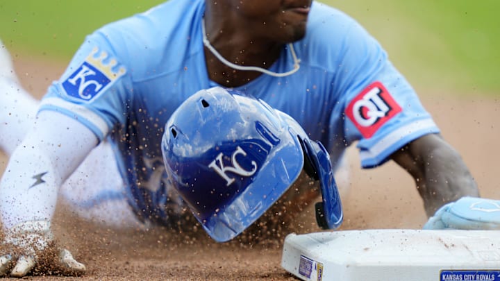Aug 13, 2025; Kansas City, Missouri, USA; Kansas City Royals second baseman Tyler Tolbert (2) loses his helmet as he steals third base during the eighth inning against the Washington Nationals at Kauffman Stadium. Mandatory Credit: Jay Biggerstaff-Imagn Images