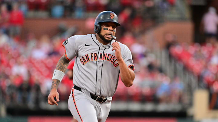 Sep 6, 2025; St. Louis, Missouri, USA; San Francisco Giants designated hitter Dominic Smith (7) digs for third base in the fourth inning against the St. Louis Cardinals off a hit by teammate San Francisco Giants third baseman Matt Chapman (not shown) at Busch Stadium. Mandatory Credit: Tim Vizer-Imagn Images