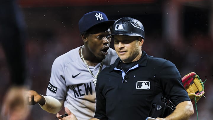 Jun 24, 2025; Cincinnati, Ohio, USA; New York Yankees third baseman Jazz Chisholm Jr. (13) reacts after being ejected by umpire Mark Wegner (14) in the ninth inning in the game against the Cincinnati Reds at Great American Ball Park. Mandatory Credit: Katie Stratman-Imagn Images