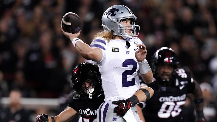 Sep 26, 2026; Cincinnati, Ohio, USA; Kansas State Wildcats quarterback Avery Johnson (2) throws a pass as he is hit by Cincinnati Bearcats linebacker Filip MacIorowski (12) in the first half at Nippert Stadium. Mandatory Credit: Aaron Doster-Imagn Images Sep 26, 2026; Cincinnati, Ohio, USA; Kansas State Wildcats quarterback Avery Johnson (2) throws a pass as he is hit by Cincinnati Bearcats linebacker Filip MacIorowski (12) in the first half at Nippert Stadium. Mandatory Credit: Aaron Doster-Imagn Images