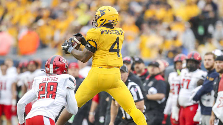 Sep 23, 2023; Morgantown, West Virginia, USA; West Virginia Mountaineers running back CJ Donaldson Jr. (4) catches a pass against the Texas Tech Red Raiders during the fourth quarter at Mountaineer Field at Milan Puskar Stadium. Sep 23, 2023; Morgantown, West Virginia, USA; West Virginia Mountaineers running back CJ Donaldson Jr. (4) catches a pass against the Texas Tech Red Raiders during the fourth quarter at Mountaineer Field at Milan Puskar Stadium.