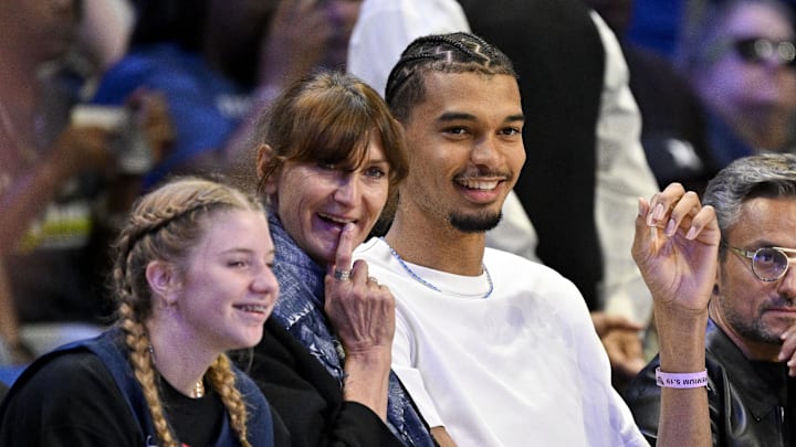 May 19, 2025; Arlington, Texas, USA; San Antonio Spurs forward Victor Wembanyama watches a game between the Dallas Wings and the Seattle Storm during the first half at College Park Center.