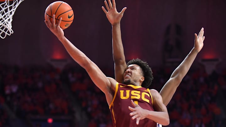 Jan 11, 2025; Champaign, Illinois, USA;  USC Trojans guard Desmond Claude (1) drives past Illinois Fighting Illini forward Morez Johnson Jr. (21) and to the basket during the second half at State Farm Center. Mandatory Credit: Ron Johnson-Imagn Images