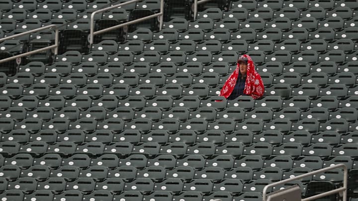 Lone Twins fan watches in the rain. Lone Twins fan watches in the rain.