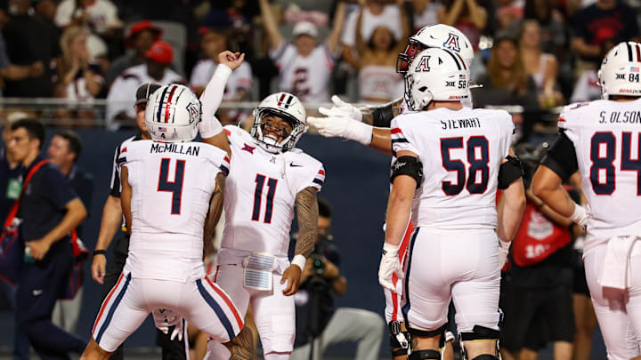 Aug 31, 2024; Tucson, Arizona, USA; Arizona Wildcats wide receiver Tetairoa McMillan (4) celebrates touchdown with Arizona Wildcats quarterback Noah Fifita (11) during first quarter at Arizona Stadium. Mandatory Credit: Aryanna Frank-Imagn Images