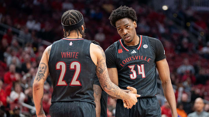 Louisville Cardinals guard Tre White (22) celebrates Emmanuel Okorafor        s (34) foul during