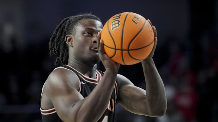Feb 21, 2024; Cincinnati, Ohio, USA;  Oklahoma State Cowboys guard Jamyron Keller (14) attempts a free throw against the Cincinnati Bearcats in the second half at Fifth Third Arena. Mandatory Credit: Aaron Doster-Imagn Images
