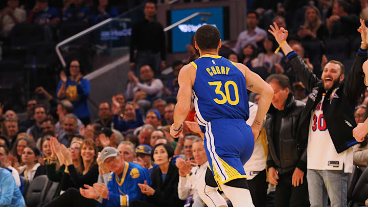 Mar 17, 2025; San Francisco, California, USA; Fans celebrate after a basket by Golden State Warriors guard Stephen Curry (30) during the second quarter against the Denver Nuggets at Chase Center. Mandatory Credit: Kelley L Cox-Imagn Images