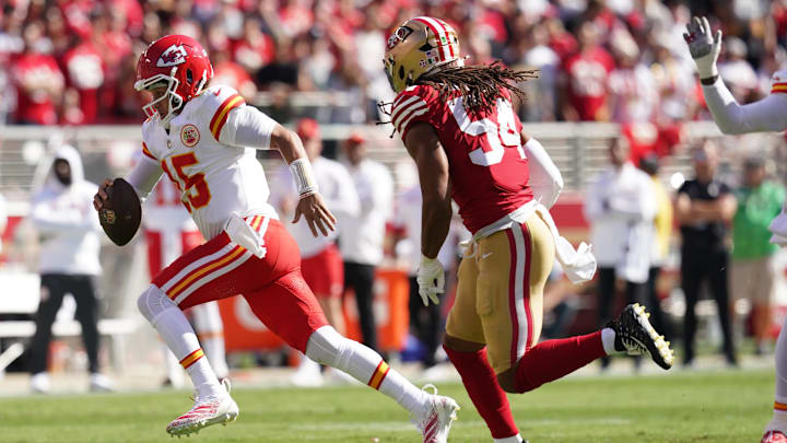 Oct 20, 2024; Santa Clara, California, USA; Kansas City Chiefs quarterback Patrick Mahomes (15) runs past San Francisco 49ers linebacker Fred Warner (54) in the first quarter at Levi's Stadium. Mandatory Credit: Cary Edmondson-Imagn Images