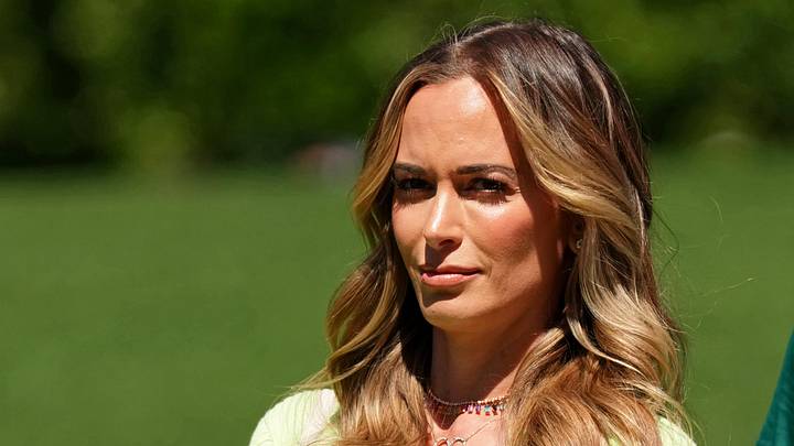 Apr 9, 2023; Augusta, Georgia, USA; Jena Sims, wife of Brooks Koepka (not pictured) watches from the fourth hole during the final round of The Masters golf tournament. Apr 9, 2023; Augusta, Georgia, USA; Jena Sims, wife of Brooks Koepka (not pictured) watches from the fourth hole during the final round of The Masters golf tournament.