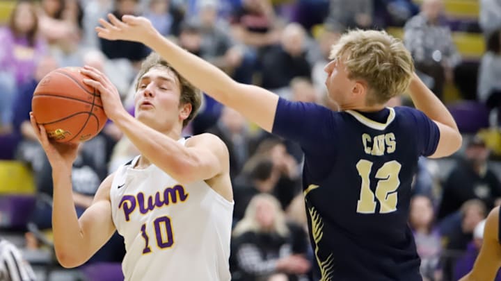Plum junior Owen Proskin, left, attempts to put up a shot past Kiski Area's  Colin Keller Jan. 10 at Plum High School. Proskin scored five points in the Mustangs' 57-30 loss.