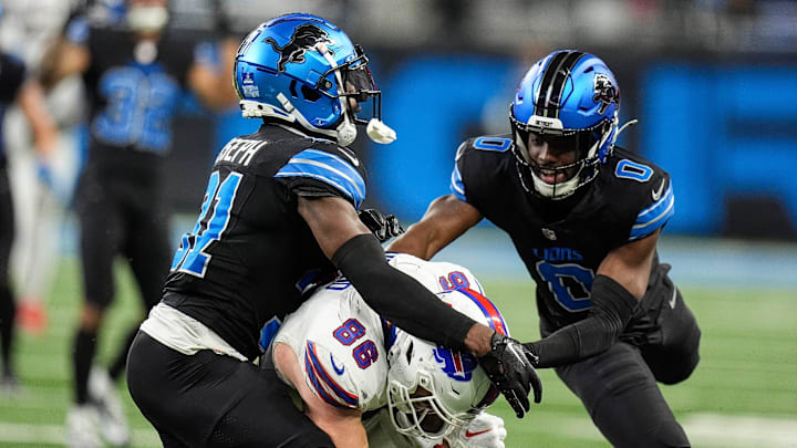 Detroit Lions safety Kerby Joseph (31), left, cornerback Terrion Arnold (0), tackle Buffalo Bills tight end Dalton Kincaid (86) during the second half at Ford Field in Detroit on Sunday, Dec. 15, 2024.
