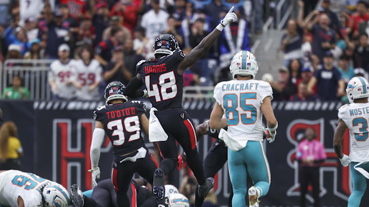 Dec 15, 2024; Houston, Texas, USA; Houston Texans linebacker Christian Harris (48) reacts after the Texans recover a fumble during the second quarter against the Miami Dolphins at NRG Stadium. Mandatory Credit: Troy Taormina-Imagn Images