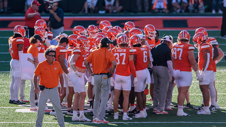 Oct 5, 2024; Stillwater, Oklahoma, USA; Oklahoma State Cowboys coach Mike Gundy on the field with his team during a break in play of the third quarter against the West Virginia Mountaineers at Boone Pickens Stadium. Mandatory Credit: William Purnell-Imagn Images
