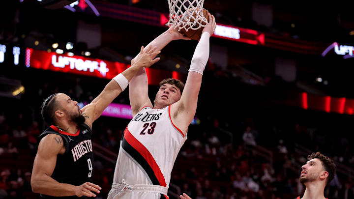 Nov 22, 2024; Houston, Texas, USA; Portland Trail Blazers center Donovan Clingan (23) dunks against Houston Rockets forward Dillon Brooks (9) during the third quarter at Toyota Center. Mandatory Credit: Erik Williams-Imagn Images