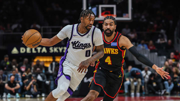 Mar 28, 2026; Atlanta, Georgia, USA; Sacramento Kings guard Malik Monk (0) drives the ball towards the basket against Atlanta Hawks guard Gabe Vincent (4) during the first quarter at State Farm Arena. Mandatory Credit: Jordan Godfree-Imagn Images Mar 28, 2026; Atlanta, Georgia, USA; Sacramento Kings guard Malik Monk (0) drives the ball towards the basket against Atlanta Hawks guard Gabe Vincent (4) during the first quarter at State Farm Arena. Mandatory Credit: Jordan Godfree-Imagn Images