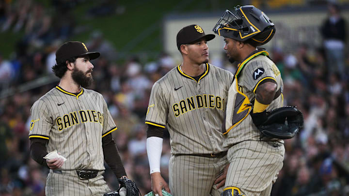 Apr 8, 2025; West Sacramento, California, USA; San Diego Padres catcher Martín Maldonado (15) visits the mound with third base Manny Machado (13) and pitcher Dylan Cease (84) during the first inning of the game against the Athletics at Sutter Health Park. Mandatory Credit: Ed Szczepanski-Imagn Images