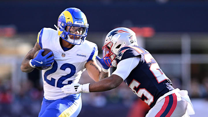 Nov 17, 2024; Foxborough, Massachusetts, USA; Los Angeles Rams running back Blake Corum (22) runs with the ball against New England Patriots cornerback Marcus Jones (25) during the first half at Gillette Stadium. Mandatory Credit: Brian Fluharty-Imagn Images
