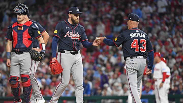 May 27, 2025; Philadelphia, Pennsylvania, USA; Atlanta Braves pitcher Dylan Lee (52) hands the ball to manager Brian Snitker (43) during the seventh inning against the Philadelphia Phillies at Citizens Bank Park. Mandatory Credit: Eric Hartline-Imagn Images